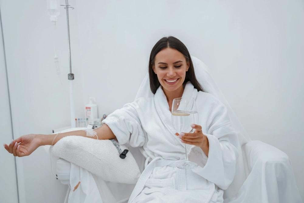 A woman in white robe sitting on the floor.