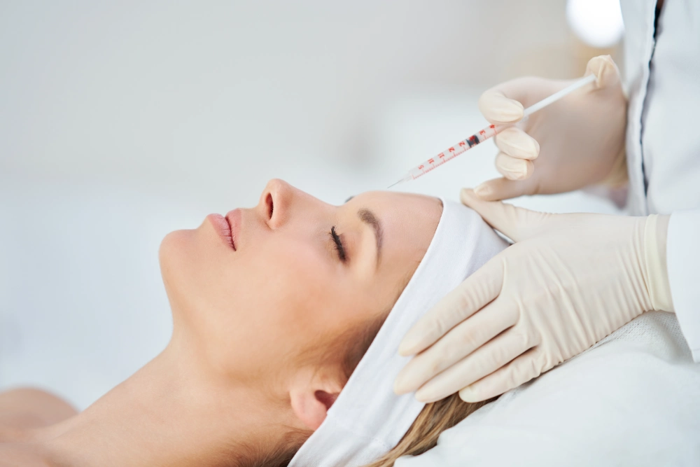 A woman getting her face waxed at the spa